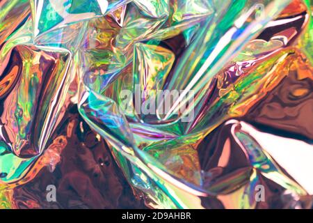 Colorful blurred holographic background. Wrinkled iridescent foil texture. Soft focus pearlescent surreal waves. Stock Photo