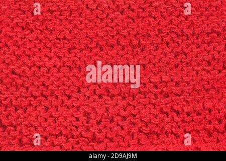 Hand knitting red background. Vintage pattern of rustic hand knitting of the middle of the last century. Red vintage wool close-up background and text Stock Photo