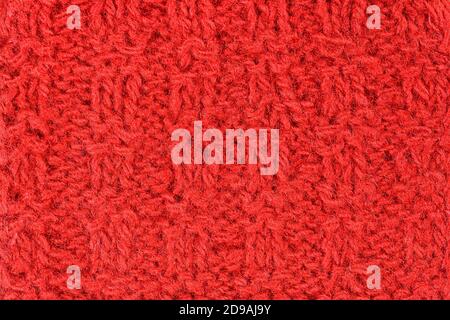 Hand knitting red background. Vintage pattern of rustic hand knitting of the middle of the last century. Red vintage wool close-up background and text Stock Photo