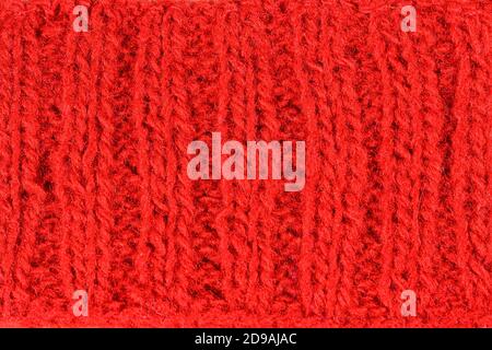 Hand knitting red background. Vintage pattern of rustic hand knitting of the middle of the last century. Red vintage wool close-up background and text Stock Photo