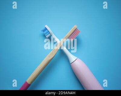 two ultrasonic electric toothbrushes on a blue background Stock Photo