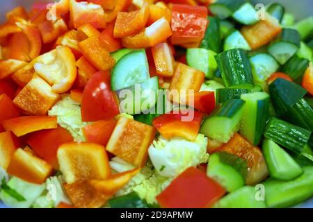 Coarsely chopped fresh vegetable salad in a large plate. Top view Stock Photo