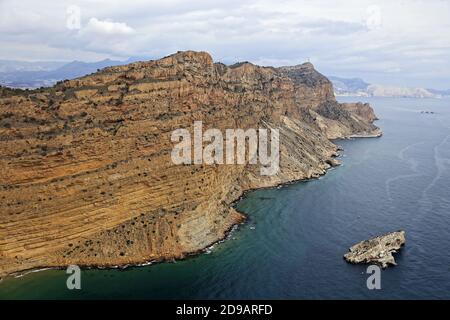 Spain, Alicante province, city of Altea: aerial view of the peninsula and its steep cliffs of the Serra Gelada and coastal environment nature reserve, Stock Photo