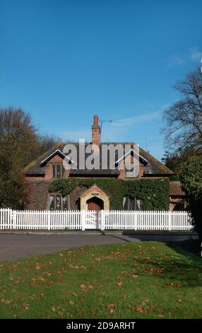 white picket fence outside a pretty country cottage Stock Photo
