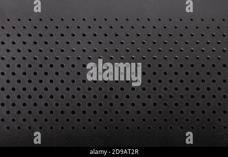 Black perforated plastic texture, surface with dots Stock Photo