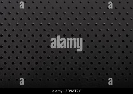 Black perforated plastic texture, surface with dots Stock Photo