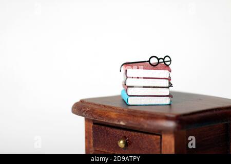 a pile of books and glasses on the table isolated against white background. Horizontal image. Image contains copy space Stock Photo