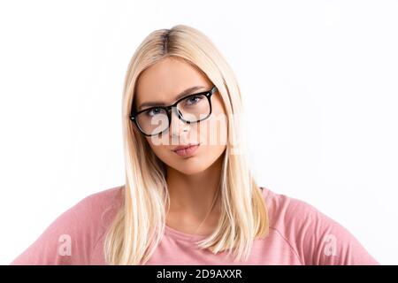 Serious blonde woman in eyeglasses looking at camera isolated on white Stock Photo