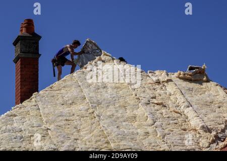 A builder installs insulation on a renovated house in Melbourne Australia Stock Photo