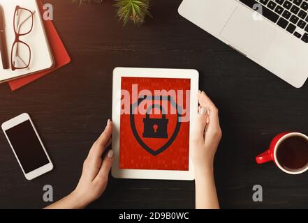 Business woman works on tablet with red screen and blocked website Stock Photo