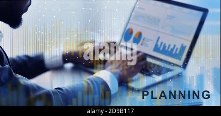 Businessman Working On Laptop With Financial Graphs And Charts, Analyzing Economics Statistics Stock Photo
