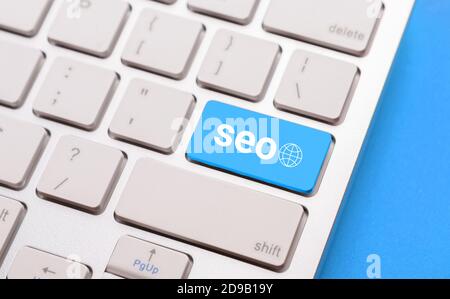 Closeup Of Computer Keyboard With Word Seo On Blue Background Stock Photo