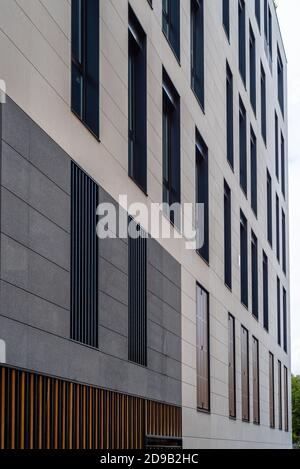 Madrid, Spain - October 4, 2020: New residential building with stone ventilated facade and wooden lattice shutters Stock Photo