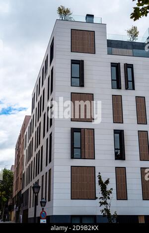 Madrid, Spain - October 4, 2020: New residential building with stone ventilated facade and wooden lattice shutters Stock Photo