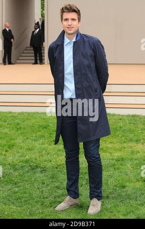 Greg James attends the Burberry Prorsum Menswear Spring/Summer 2014 catwalk show, Perks Field, Kensington Gardens, London. © Paul Treadway Stock Photo