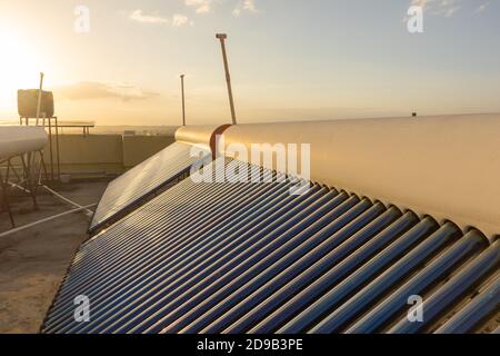 solar panels and tubes installed on house roof tops and building tops  to conserve energy for water heating Stock Photo