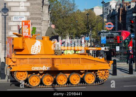 Westminster, London, UK. 4th Nov, 2020. An ex British Army Abbott tank (more correctly a self propelled gun) has been driving around Westminster and Parliament in protest at the closure of gyms during the COVID-19 Coronavirus lockdown. The orange de-mobbed Vickers Abbot FV433 armoured vehicle is advertising Grenade, a nutrition bar. In Great George Street Stock Photo