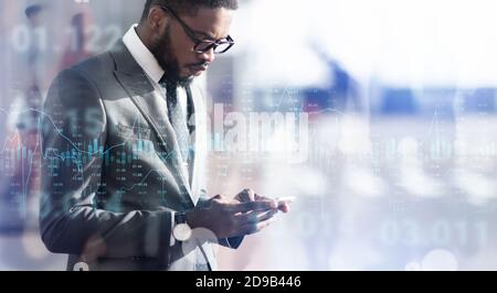 Forex trading graph chart layered over black businessman using smartphone outdoors, collage Stock Photo