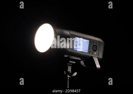 Studio flash light firing on black background Stock Photo