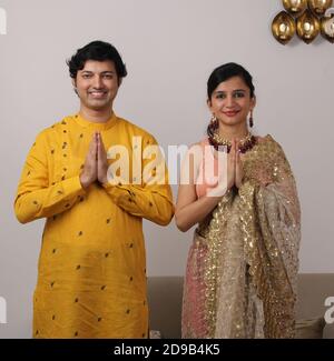 Portrait of Indian Married couple in traditional wear in Namaskara /prayer / welcoming pose. Stock Photo