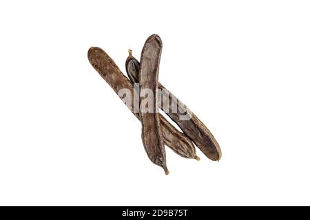Carob beans isolated on white background. Healthy organic sweet carob pods. Top view. Stock Photo