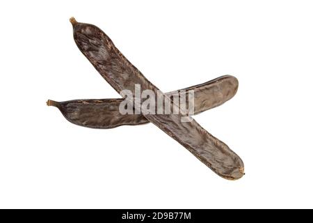 Carob pods isolated on white background. Healthy organic sweet carob pods. Top view. Stock Photo
