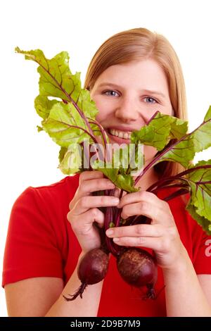 Blonde woman with beetroot (Beta vulgaris subsp. Vulgaris var. Conditiva) Stock Photo