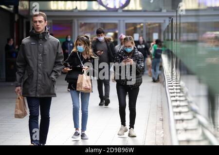 Birmingham, UK. 4th November 2020. Two young women walk from Grand Central, home to New Street Railway Station and many restaurants set to close for the lockdown. Credit: Ryan Underwood/Alamy Live News Stock Photo