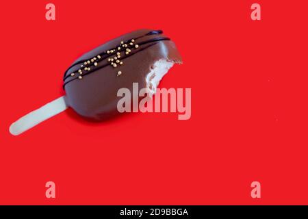 ice cream cake in chocolate. Chocolate ice cream on a red background. Chocolate cake with curd cream. Bright flatley. Handmade food Stock Photo