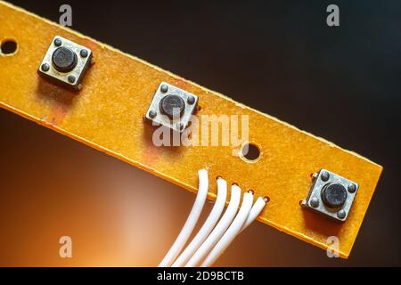 buttons on the circuit Board close up on a black background. Stock Photo
