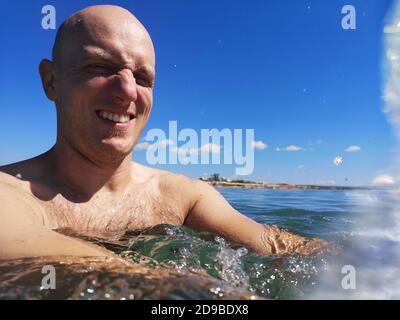 Smiling man in the sea, Italy Stock Photo