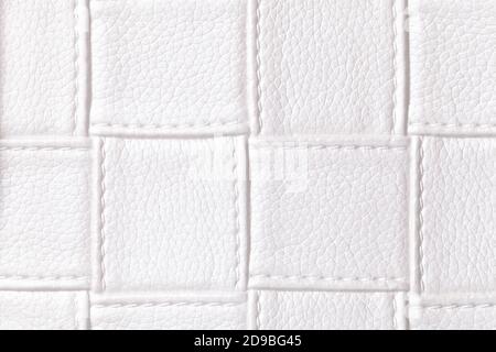 Texture of white leather background with square pattern and stitch, macro. Abstract backdrop from modern decorative light textile with geometric shape Stock Photo