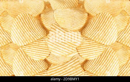 Namkeen - Potato Chips Wafers, corrugated golden chips with texture, Fluted chips with potatoes, tasty ridged potato chips, background image. Stock Photo