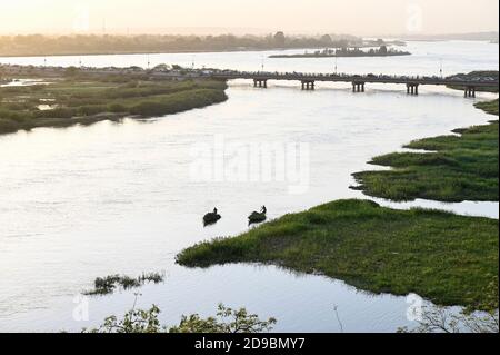 NIGER, Niamey, river Niger and bridge /Fluß Niger , Holzboot Pinasse Stock Photo