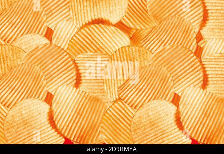 Namkeen - Potato Chips Wafers, corrugated golden chips with texture, Fluted chips with potatoes, tasty ridged potato chips, background image. Stock Photo