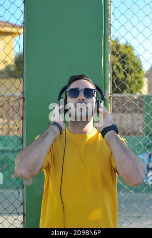 Man listening to music graffiti background Stock Photo