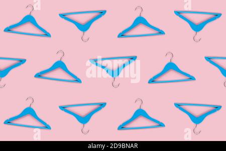 Wooden blue hanger with black paper label isolated on pink paper background. Seamless pattern mockup template, to place your design. Black friday fina Stock Photo