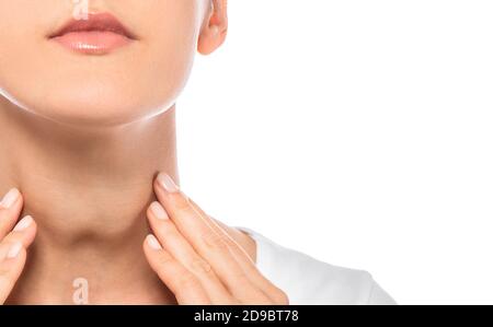 Woman palpation her neck, examine thyroid gland. Enlarged thyroid gland, close-up on white background Stock Photo