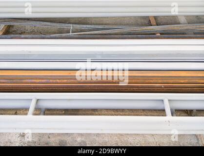 Steel pile and steel bar to storage in the construction site for ready to build the bridge near the urban street. Stock Photo