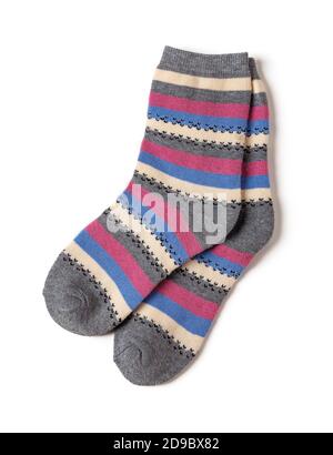 Pair of tall striped socks isolated on a white background. Gray socks with white, blue, pink stripes. Hosiery for the cold winter season. Stock Photo