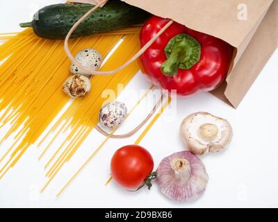 Various vegetables in the bag on a white background, top view. The concept of healthy eating, food background. Stock Photo