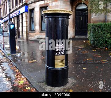 This Royal Mail post box, in Glasgow, has been painted black and gold to celebrate Black History month, October 2020. It is a tribute to Walter Tull, who was the 1st black officer in the regular British Army. He was also signed up to play for Rangers football team before being killed in action, in France, on the 25th March 1918.ALAN WYLIE/ALAMY© Stock Photo