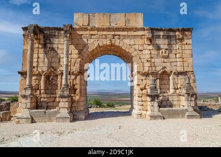 The Triumphal Arch devoted to Emperor Caracalla at the 3rd Century Ruins at Volubilis morocco Stock Photo