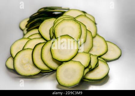 courgette,zucchini  sliced in very thin rounds.selective focus Stock Photo