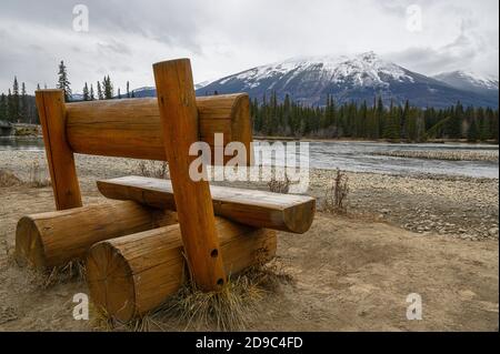 large wooden bench on along a popular hiking trail in Jasper National Park, Canada Stock Photo
