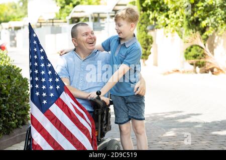 Young boy with Disabled father, we love our country Stock Photo