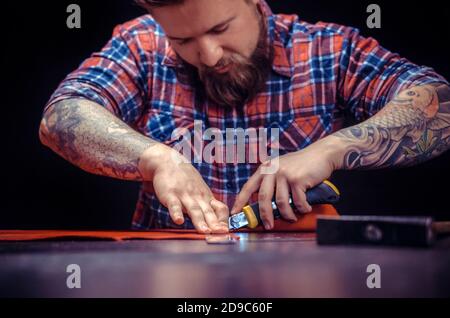 Man working with leather forms new leather product Stock Photo
