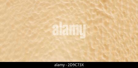 Clean sea sand on the beach, background surface texture of the coast, panoramic abstraction, Stock Photo