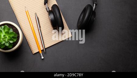 Business desk workplace and office objects over black leather backdrop. Top view flat lay with copy space for your text Stock Photo