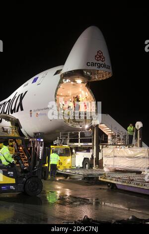 Glasgow Prestwick Airport, Ayrshre, Scotland, UK, A Boeing Carolux 747-8f unloads at the airport at night time flooldlighting helps the operation Stock Photo